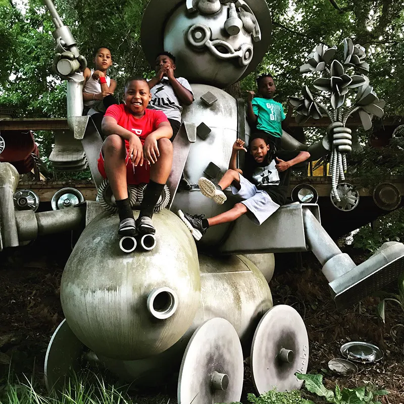 Elementary youth following art lessons in the Peace Garden in Asheville