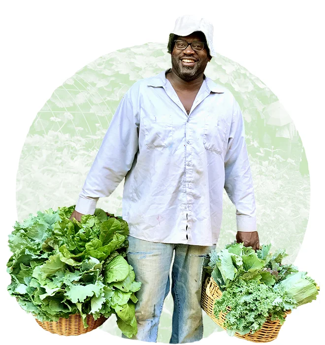 Co-Founder DeWayne Barton holding harvested greens from the garden